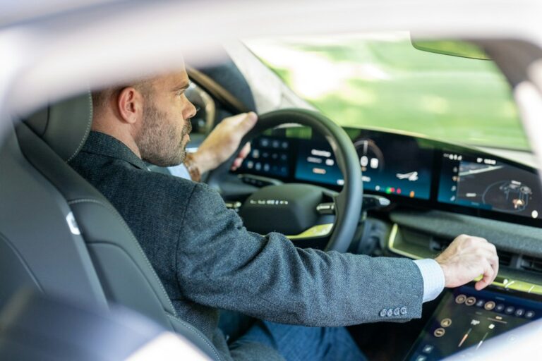 Man driving 2023 Lucid Air electric vehicle — illustrative photo for used lucid air buying guide